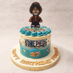 The base of this One Piece Luffy birthday cake for kids features a blue to white ombre pattern that is meant to recreate the look of the sea, adding to the aquatic design. 