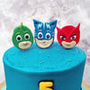 The three stars of the show: Conor, Greg and Amaya watch over this PJ mask cake from on top, just like how they do in the animated series. The heads of these cartoons on top of this Cat boy cake are made entirely edible and they come all suited up in their superhero costumes, ready to fight crime