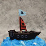 The pirate ship on this pirate theme cake is carved out in a way that resembles both chocolate and an actual wooden ship sailing through this kids birthday cake . The pirate flag hoisted upright on this cartoon cake is in a dangerous shade of red with a skill and the birthday boy's or birthday girl's name on it And even an anchor has been added onto the design 