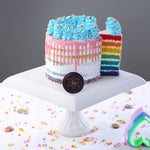 Cut view of Rainbow cake with 7 layers of sponge and blue cream cheese piping on top