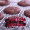 Molted raspberry compote mixed with white chocolate running out of our dark chocolate berry burst cookie