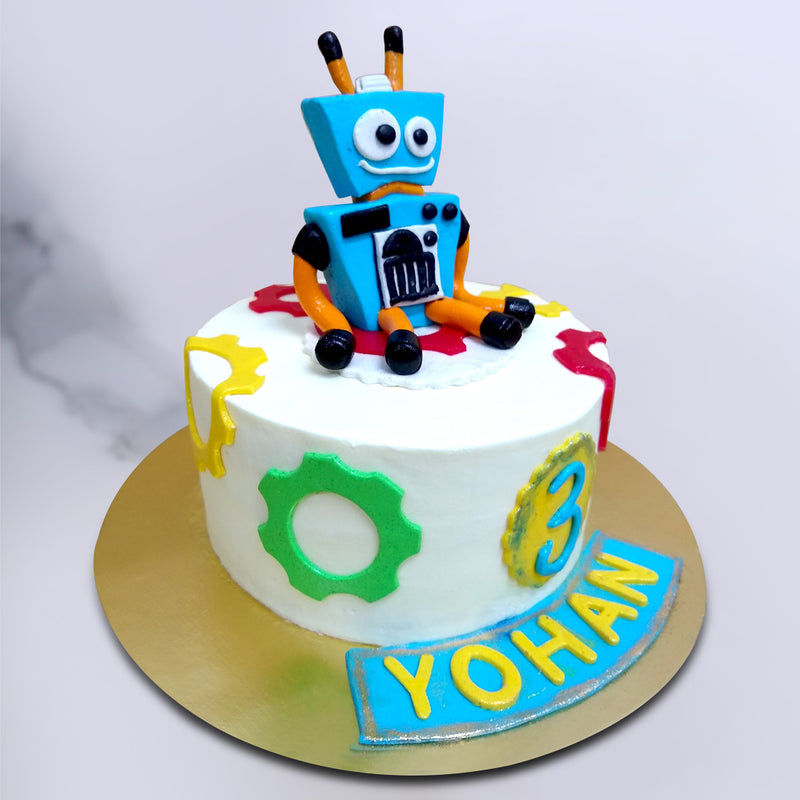 This kids birthday cake for boy/girl comes in bright white with colourful mechanical parts adorning the whole base that appear as if they've fallen out of the robot.