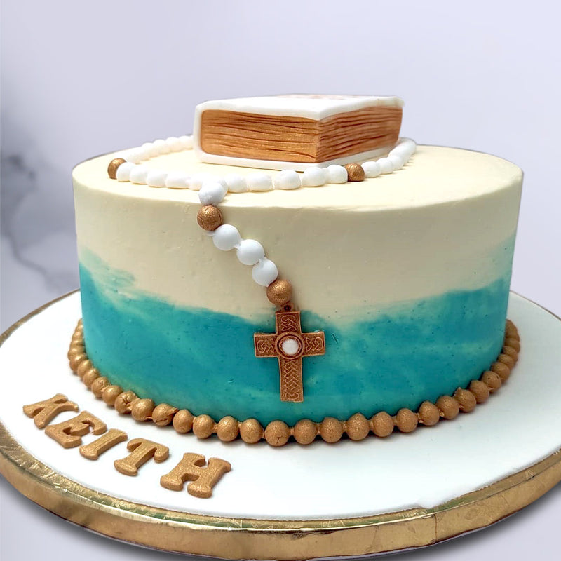 The simple tones used in the colour scheme of this catholic cake reflects the peace and simplicity of following a pious life. The rosary cake topper depicts the string of beads used to  keep count in a prayer. This rosary comes life-sized and realistic enough to be able to pick it up and not just eat it but wear it too! 