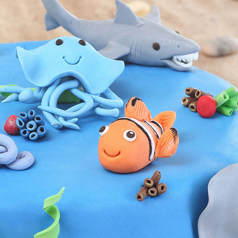 Nemo cake on top of our sea theme cake, This clown fish (nemo) is made of marzipan and taste delicious