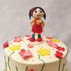 A figurine of a little girl in her red and yellow school uniform  with a brooch on it playing in the middle of this field of flowers forms the centrepiece of this school girl cake design.