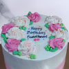 Zoomed view of simple buttercream flower cake to show you these beautiful pink and white flowers sitting on top of this buttercream flower birthday cake