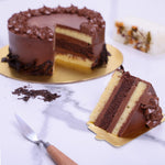 Sliced view of chocolate vanilla cake to showcase each and every layer of this wonderful cake. This choco vanilla cake has 2 layers of vanilla sponge and in between them is chocolate sponge covered with delicious chocolate buttercream