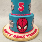 This Spiderman theme cake was also suited up in the classy red and blue colours of Spiderman's costume. Spiderman’s mask ornaments the bottom tier but bright, red buttercream piped on the bottom of both tiers.   