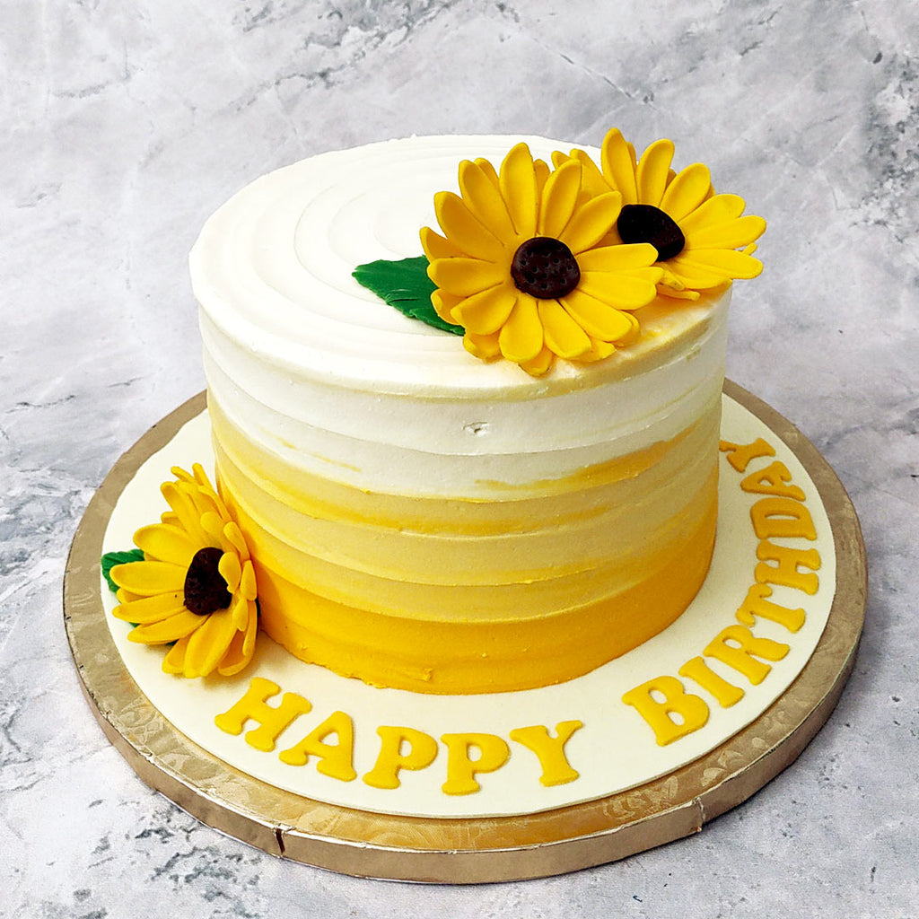 Legend has it that when sunflowers can't find the sun, they turn and face each other. This sunflower cake design is a way to ensure that you can face the brightness of the sun and the beauty of a sunflower all in one delicious sunflower themed cake.