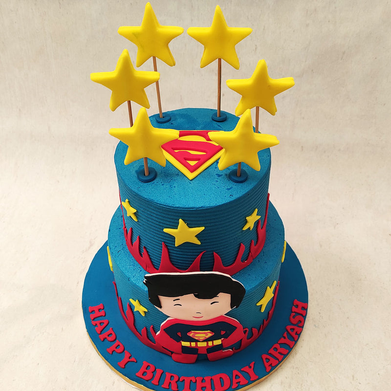  Stars adorn the entirety of this birthday cake for kids from the circumference of both tiers to lollipop-like sparklers on top in a similar yellow shade to the one on his costume.