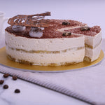 Sliced view of Tiramisu cake which shows the sprinkle coffee powder and ladyfinger inside of the cake