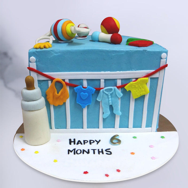 This 6-month-birthday cake has a welcoming white and baby blue colour palette to it and is designed to resemble a baby’s crib. The idea behind a halfway to one cake is to celebrate the smaller victories and since children of that age have not fully developed conscious thought, we’ve created a 6 month birthday cake that resembles home and hearth to give them the feeling of comfort in the form of a toy cake that is as fun as it is familiar.