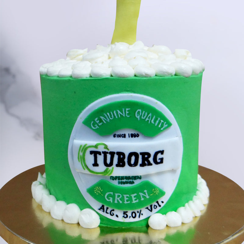 The green base of this beer mug cake resembles the Tuborg bottle but is shaped like a mug full of frothy beer. A realistic Tuborg label forms the center of this beer themed cake for him or her