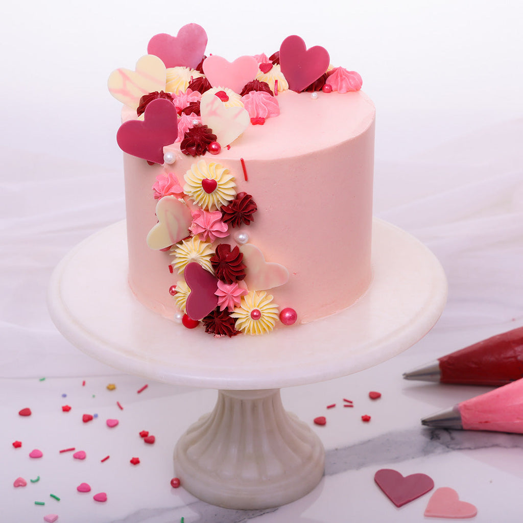 This romantic cake design will bring your love full circle and brighten up your day by adding some those famous rose-tinted glasses not just to the pink velvet cake but to your celebration of love.