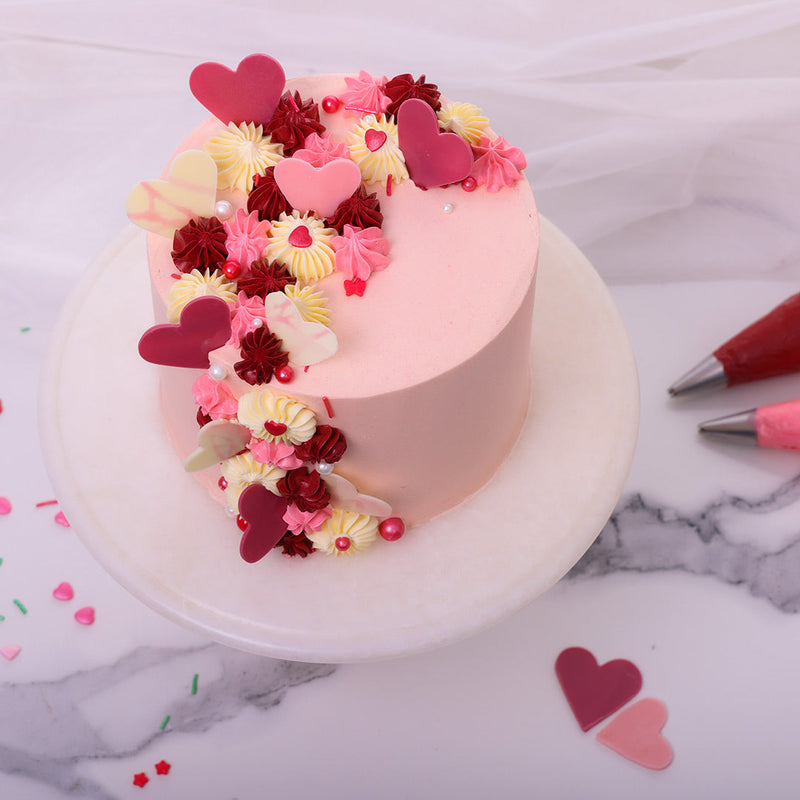 The colour pink symbolizes friendship, affection, harmony, inner peace, and approachability and love, everything that we associate with love day and could also set the perfect theme for a happy birthday cake. We even went for a light pink shade as that is used to communicate tenderness.