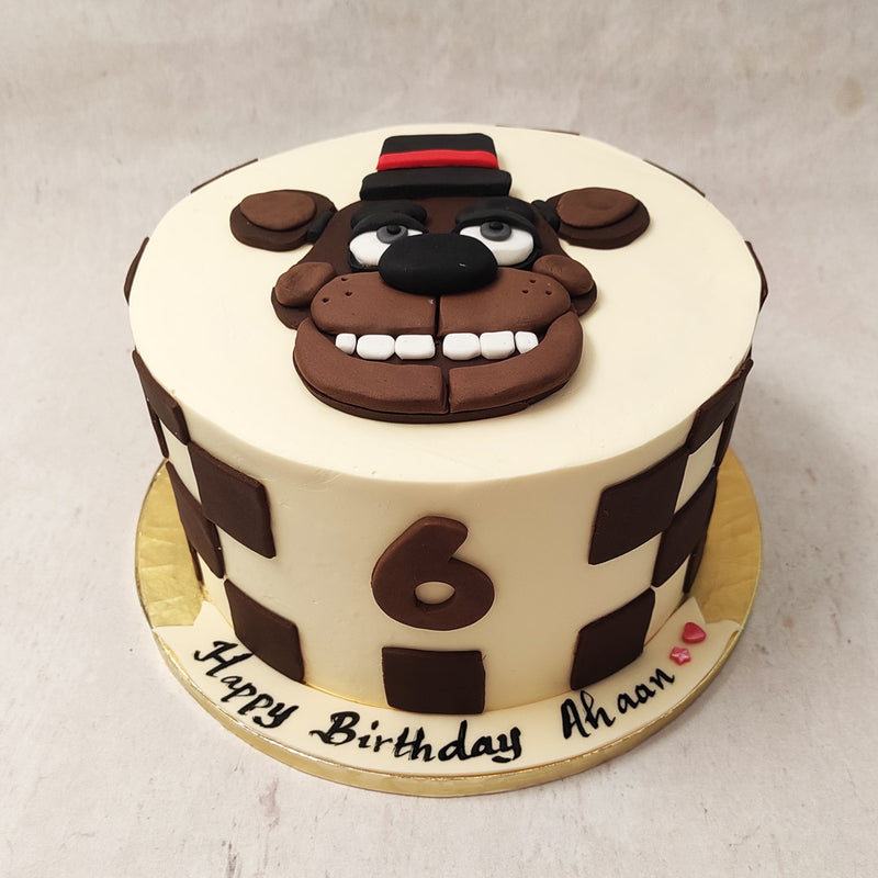 One of five animatronics of the Five Nights at Freddy's series, this gamer themed birthday cake for kids pays homage to Freddy Fazbear, the mascot of Freddy Fazbear's pizza. 