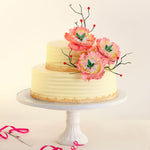 With blooming Azaleas and blossoming vines with cherry buds on this 2-tier cake design the life-like flowers adorning this 25th anniversary cake are entirely edible.  The simple, minimalist theme of this wedding cake, gives it a classy finish that is intended to make one both gawk and drool.