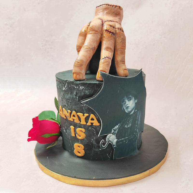 A realistic figurine of Thing, everyone's favourite handy character rests gracefully on top of this Thing cake in all his gory glory. 