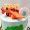 The setting of this toy aeroplane cake features a busy street with bumper-to-bumper traffic on it. Spot the cars and trucks cruising by on the base of this aeroplane theme cake on a sunny, clear-skied morning where you can see the planes swoop overhead.