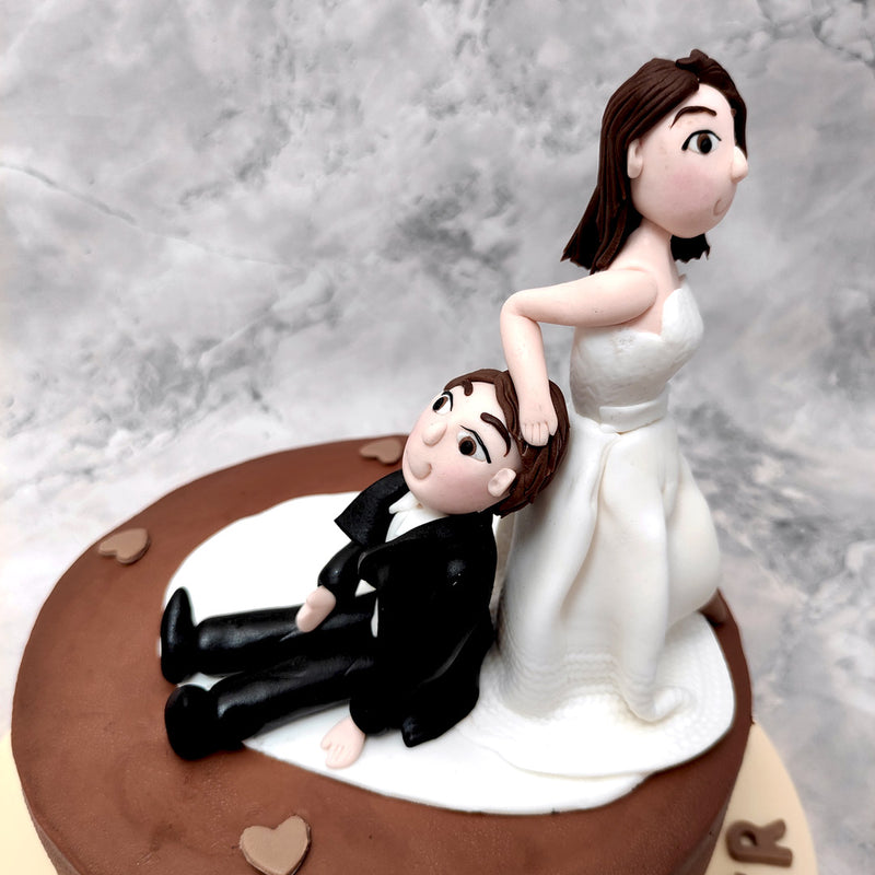 The highlight of this bachelor party cake or a bachelorette party cake is the bridal figurine, all dressed in white yanking her suited-up groom towards the altar.