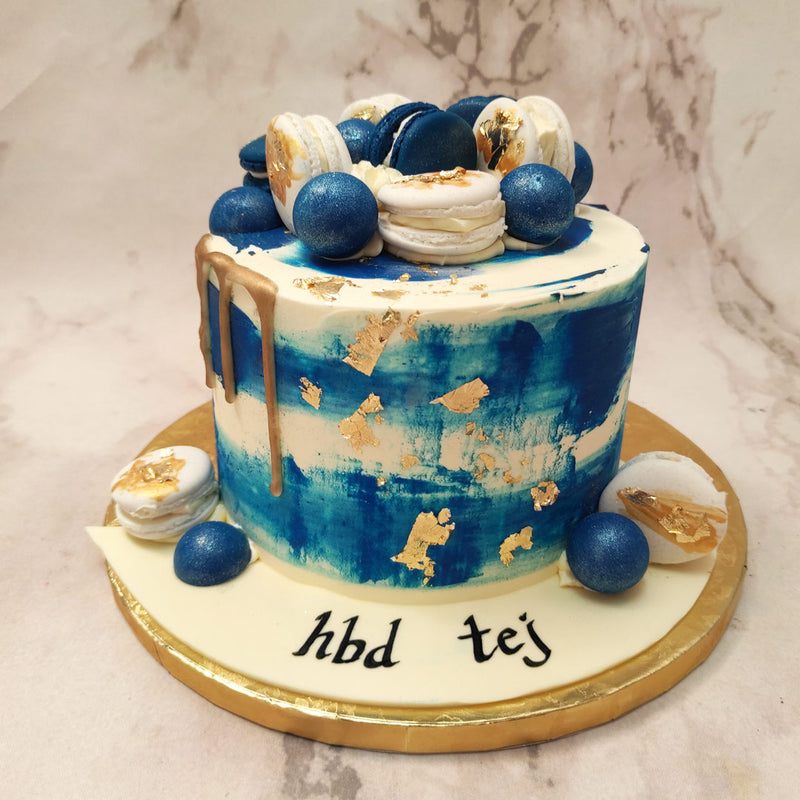 The tall base of this blue marble birthday cake for him / her is coated in smooth white buttercream and a blue buttercream frosted gradient gives it some more dynamic and appearance of it being made out of marble!