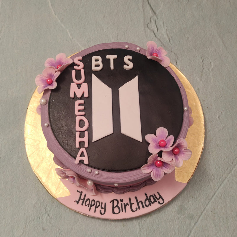  BTS' leader RM was born on September 12 1994 and his birth flower or the flower that symbolises him is Clematis, a flower of the plant called 'The Old Man Tree'. This stark purple flower is what we have edibly recreated and can be spotted peeping out from various corners of this BTS cake.  