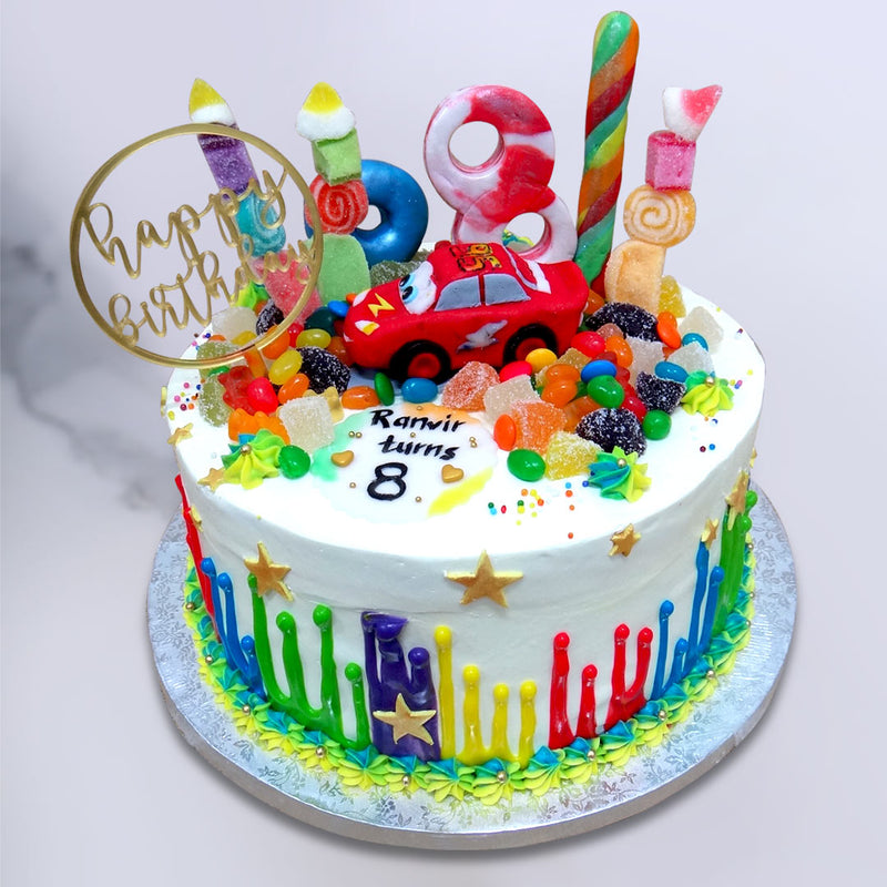 This Lightning McQueen cake design displays the scene above the clouds where Disneyland meets Candyland!