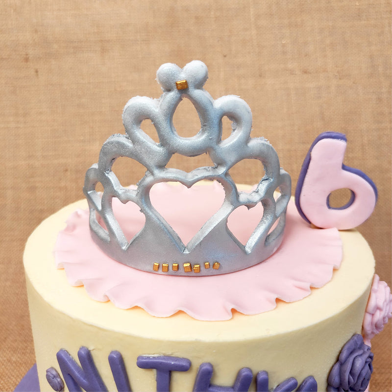 The top of this Sofia cake  is crowned with a beautiful silver tiara, embellished with tiny gold squares that can be worn or eaten or both! 