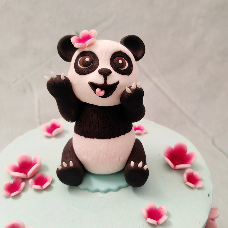 On top of this cute panda birthday cake for kids is a figurine of a friendly, baby panda with a puppy-eyed expression in her huge, twinky eyes and one of the Sakura flowers in her ear. Similar to how this cute Panda cake will melt in your mouth, it'll also melt your heart!