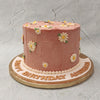 This simplistic daisy flower cake design comprises a buttercream base all pretty in pink, covered in tiny daisies. Daisies symbolise motherhood and love and would make this design perfect as a birthday cake for mom / birthday cake for wife.