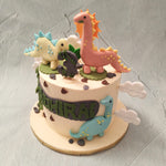  This Dinosaur themed birthday cake for kids features a white base with a theme-park like logo on it, similar to ones used in popular dino merchandise and franchises such as Jurassic Park where your little one's name will be proudly displayed