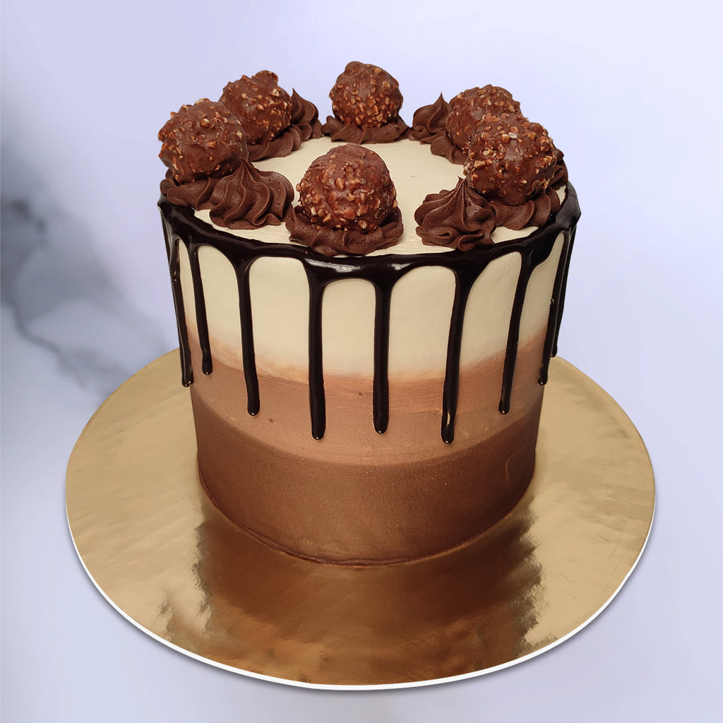Ferrero rocher cake with chocolate drips and triple coloured chocolate. This ferrero rocher chocolate drip cake is definitely a elegant cake for dad/mom or any best friend which they will remember for a long time.
