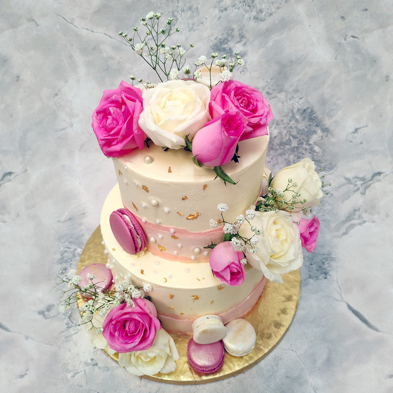 This floral marble cake also displays an array of baby's breath flowers and delicious macaroons that are just to die for or at least to drool over. 
