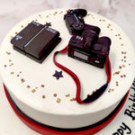 A very life-like camera and gaming console form the highlight and center-piece of this gaming console cake design. The boisterous nature of the edible equipment placed on top would normally place this gaming themed cake in the category of 'cakes for him' but this design is suited for just about all gamers, regardless of their gender.
