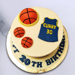 A smooth white buttercream finish coats the base of this Stephan Curry cake design and an edible yellow ribbon sits at the bottom. Stephan Curry's jersey with his number 30 has been recreated in miniature form in signature colours blue and yellow and presented on top of this Golden State Warrior Cake design.