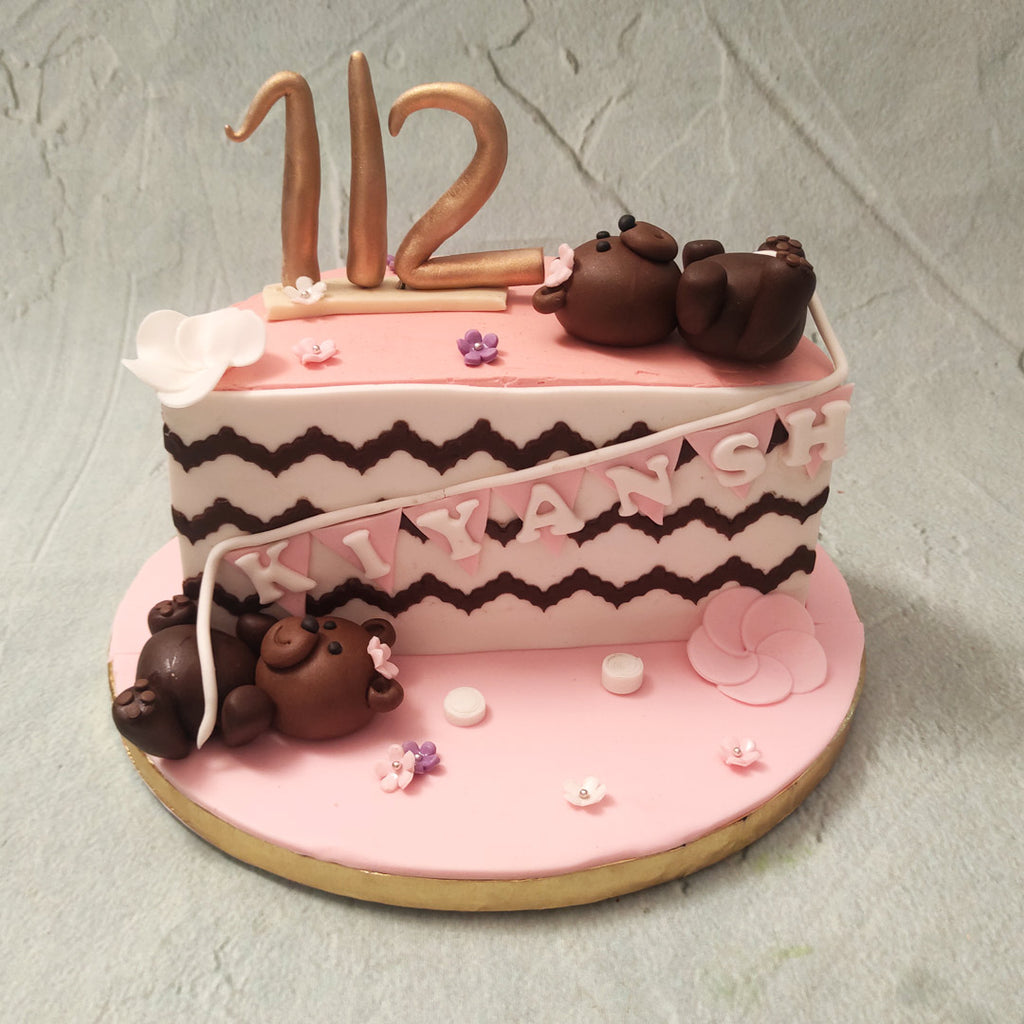  This half year cake may only be half a cake but trust us, is still the whole package that comes with all the fun. A pink base, supported by a zigzag chocolatey pattern on a white background forms the core design  of this cute teddy cake. 