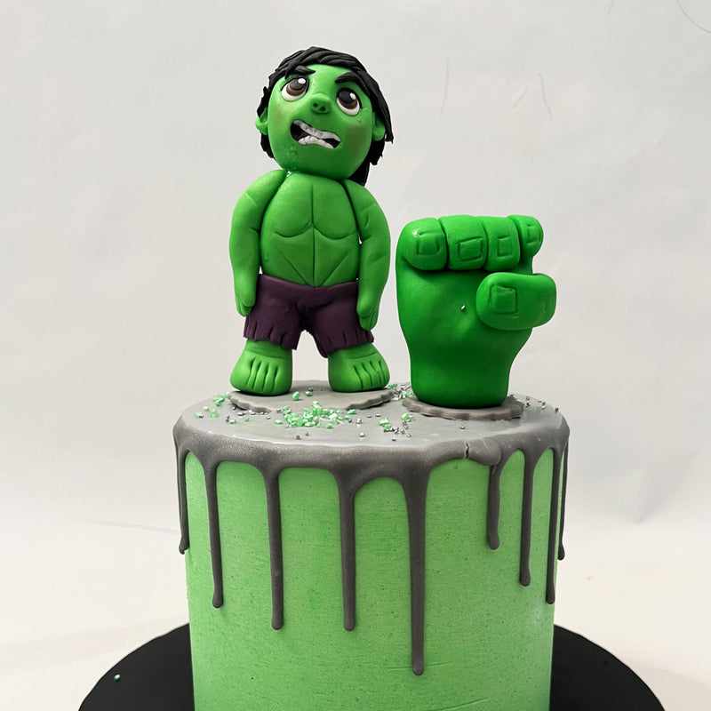  Speaking of superheroes, spot the Marvel marvel standing on top of this Incredible Hulk birthday cake for kids… the lean, green, superstrong machine: Hulk! In our version, we have caricatured a miniature figurine of this superhero and even fashioned his fist punching through the Incredible Hulk cake design. 