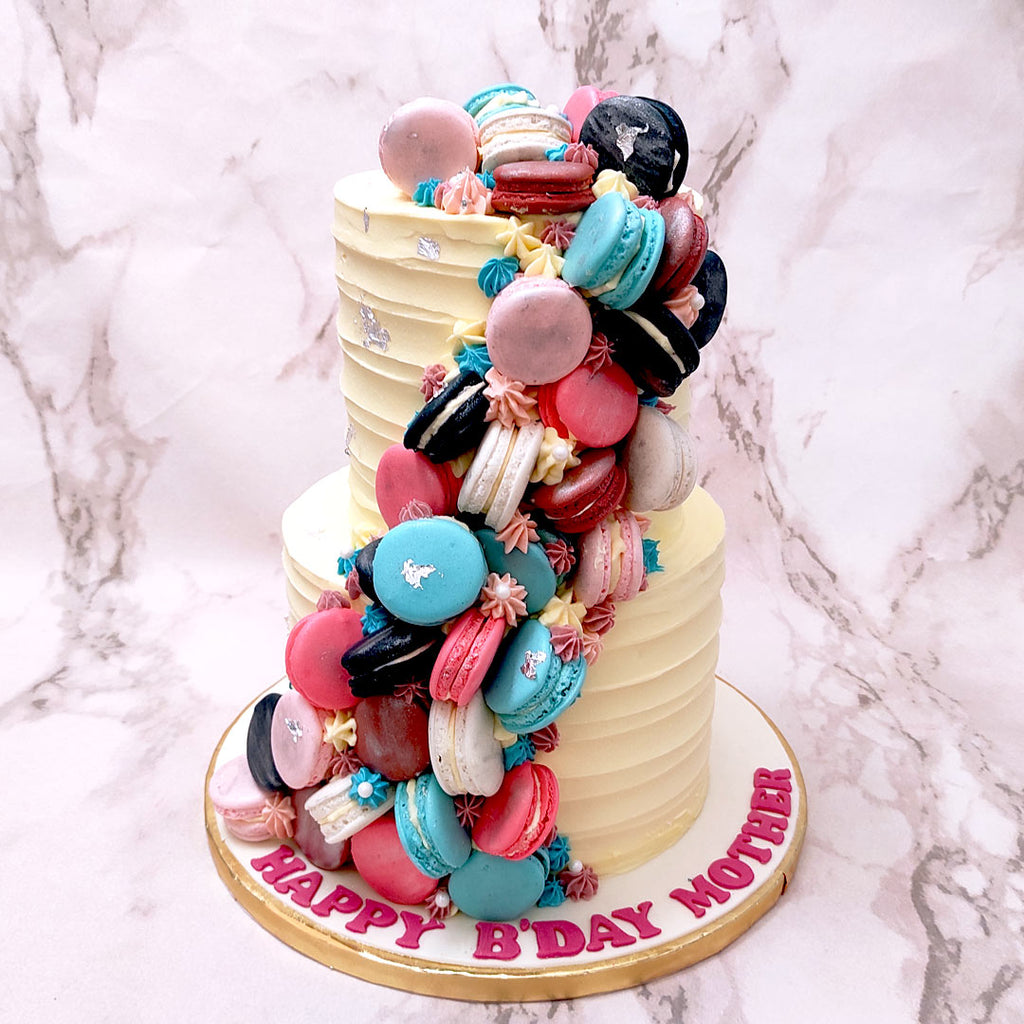 This cascading Macaron cake is a thing of beauty and of indulgence. Combined into the design of this Macaron birthday cake are an abundance of artistic and artisanal elements presented in the most mouth-watering form to celebrate you. 