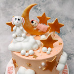 This moon and stars cake is a celebration of those with their heads in the clouds and dreams that aim for the stars. Tell your little one you love them to the moon and back with this baby on moon cake.