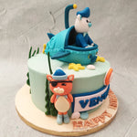 This Octonauts theme cake features Captain Barnacles the bear in the spotlight as one of the Octonauts cake toppers. He can be seen operating the submarine while Kwazii the kitten and Peso the penguin stand guard on either side of this Octonauts cake design