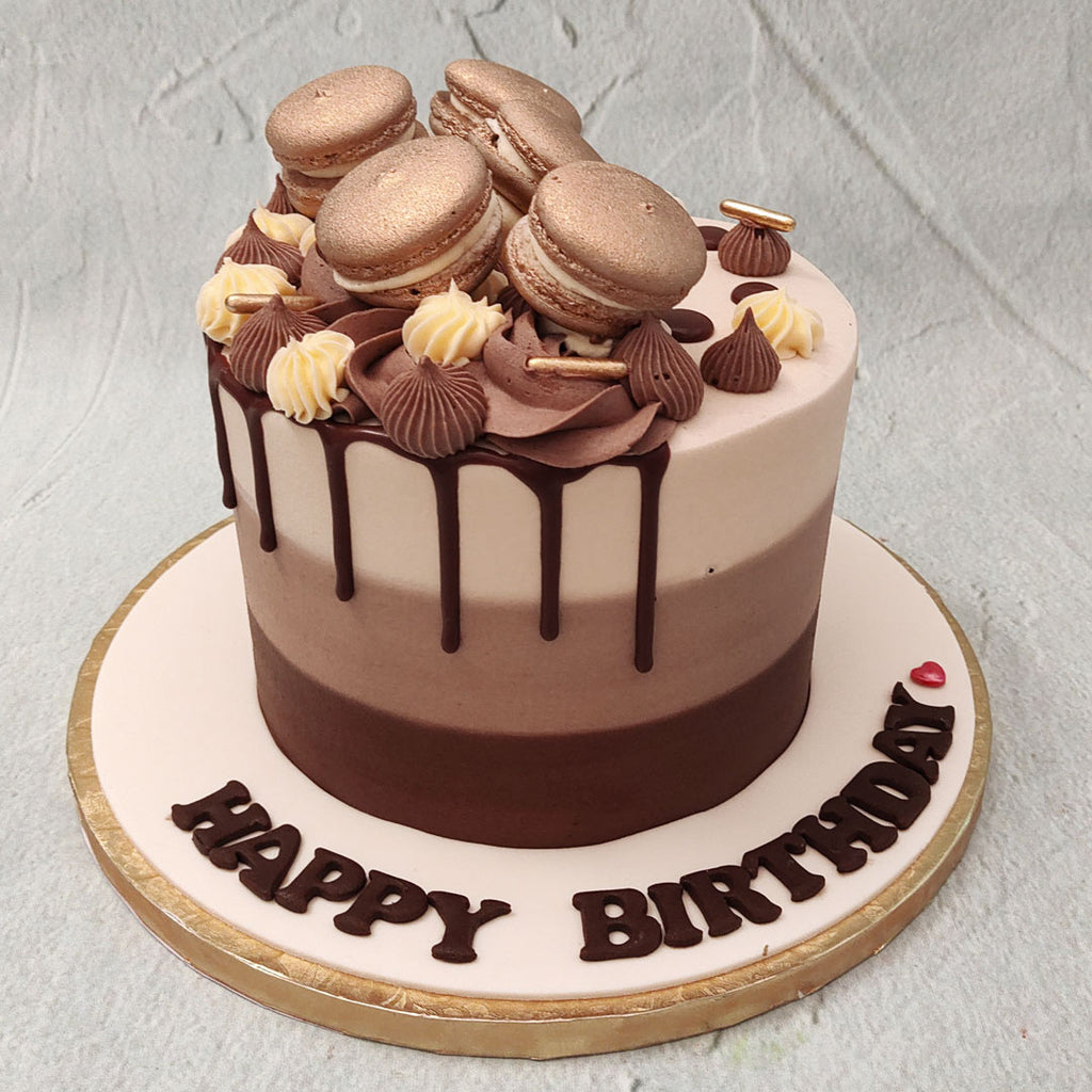 Here we have the holy Trinity of chocolate: milk, dark and white, brought to life in the form of this chocolate ombre cake design. This mono-tiered, tri-layered, ombre cake chocolate treat is designed to appeal to all your senses. 