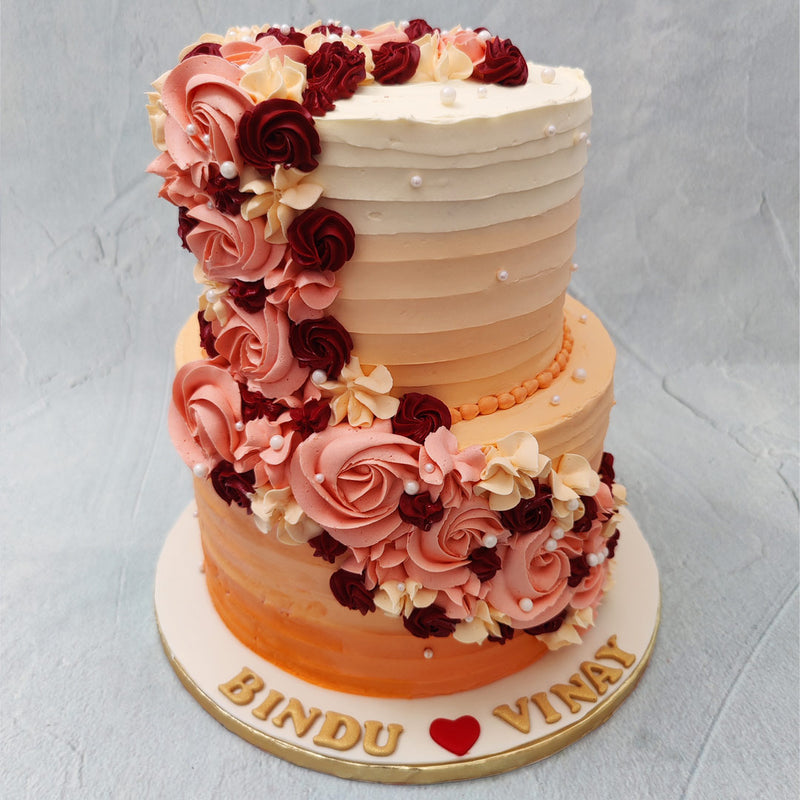Flowers are a popular symbol of love and affection, making this floral ombre engagement cake quite apt even for a wedding or anniversary celebration.  The aesthetic we’ve aimed to incorporate into this ombre rosette cake is that of a grand celebration combined with a simplistic and sophisticated design.