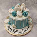 This pastel blue drip cake is created like a high-tea dessert stand with the pastel colours matching the same ambience. The blue base of this pastel blue and macaron cake design resembles a table at a high-tea event with the delicious buttercream frosting that's dropping down resembling the lacey white table cloths.
