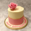  The base of this rose pink cake features two sections: the wider pink base which is divided from the narrower white top by a pink line that runs crookedly through the center of this pink fondant rose cake design creating the kind of crevice that is characteristic of a fault line cake. In several other ways as well, this cake is a unique combination of the best of both worlds. 
