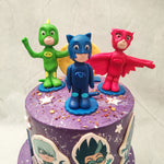 Amaya, Greg, and Connor, the ultimate superhero team known as PJ Masks, fight crime when night falls and so we've recreated the night-time, city landscape. This PJ Masks birthday cake for kids features a grand purple background and white stars on both tiers.