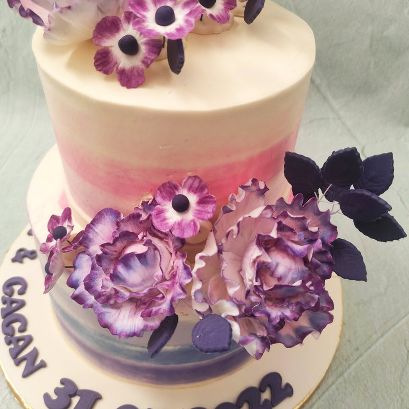  The flowers on this purple floral cake resemble petunias which have grown over time to symbolise desire, hope and calmness, all the sentiments one would want to attach to their wedding / engagement day and thereby their wedding / engagement cake design.