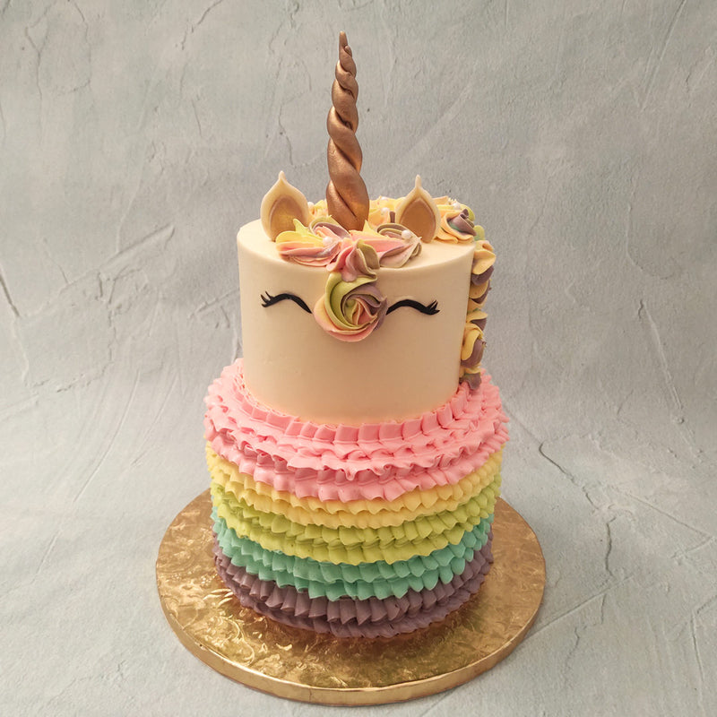 This rainbow ruffled unicorn cake is a children's paradise full of colours, treats and magical things. The design of this 2 tier rainbow unicorn cake is meant to serve up fantasy on a very platter.