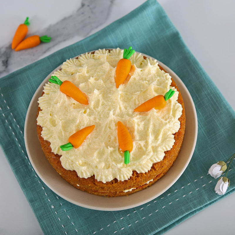 Top view of Liliyum's healthy carrot cake, This Cake contains 5 small carrots on top of the carrot cake