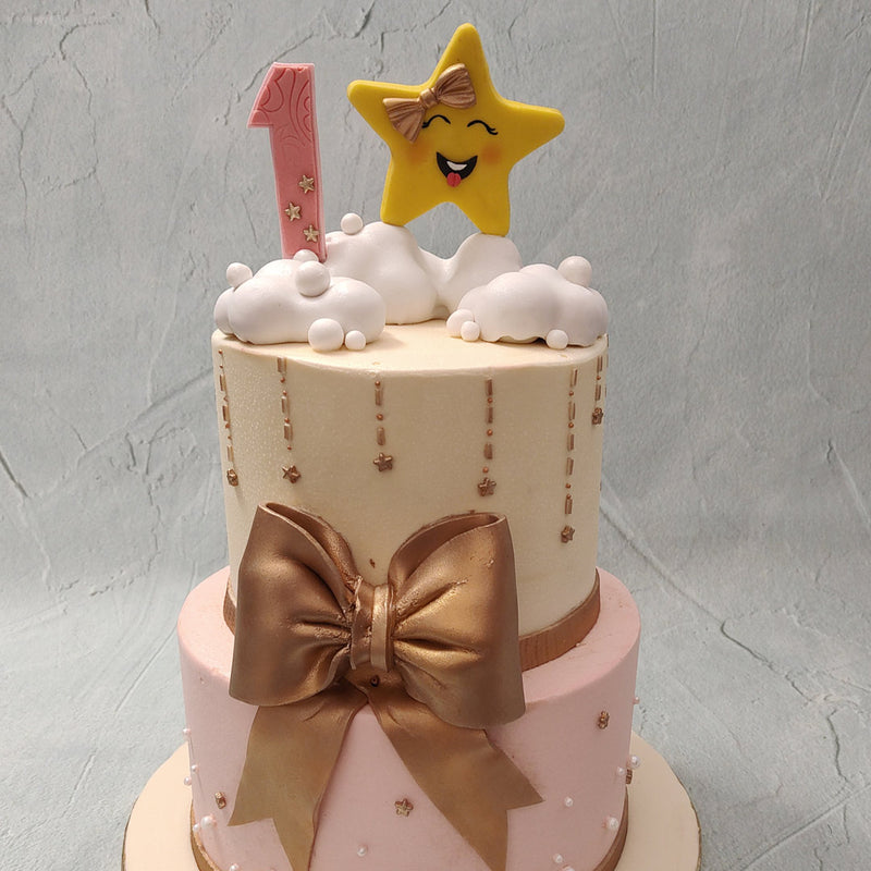 This twinkle twinkle little star birthday cake for kids comes in a two-tier design. Here we've employed the use of beautiful pastel colours to give it a little bit of a dreamy finish. The bottom tier is coated in pink buttercream and the top on white but regardless of the colour, both are sure to just melt in your mouth.