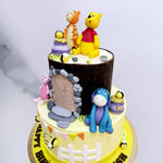 Realistic, edible, miniature, stuffed toy versions of all our favourite friends: Iyor, Piglet, Tigger and of course Winnie The Pooh have been recreated around the top tier of this Winnie the Pooh theme cake adding more dynamic to this already fun-filled design.